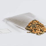 Genmaicha tea spilling out of a Soilon tea bag