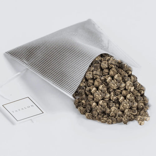 Jasmine Pearls tea spilling out of a Soilon tea bag