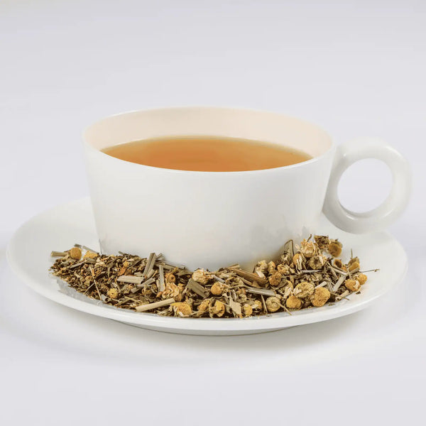 Serenity tea in a white teacup with loose leaf tea in a saucer