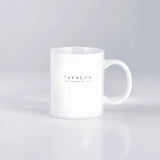 White mug with 'Tavalon' branding on a light gray background